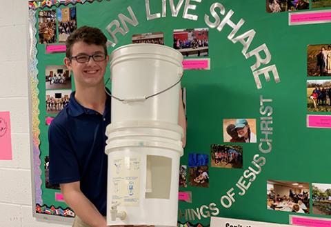 Student with water filters for Haiti mission trip