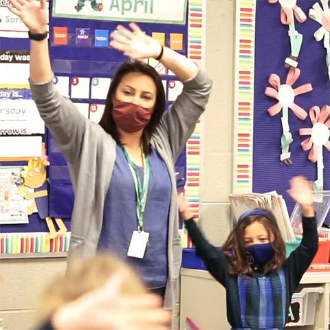 A teacher and a student start the school day dancing to a song.